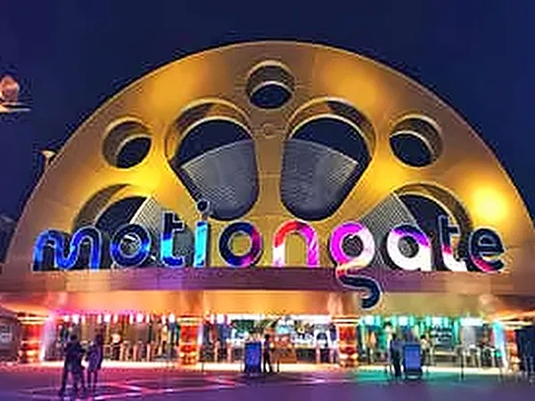 Illuminated motiongate Dubai entrance arch at dusk