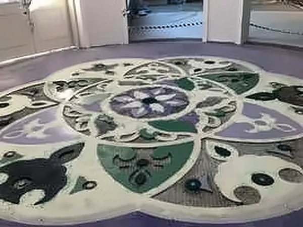 Decorative stone mosaic floor medallion in purple and green