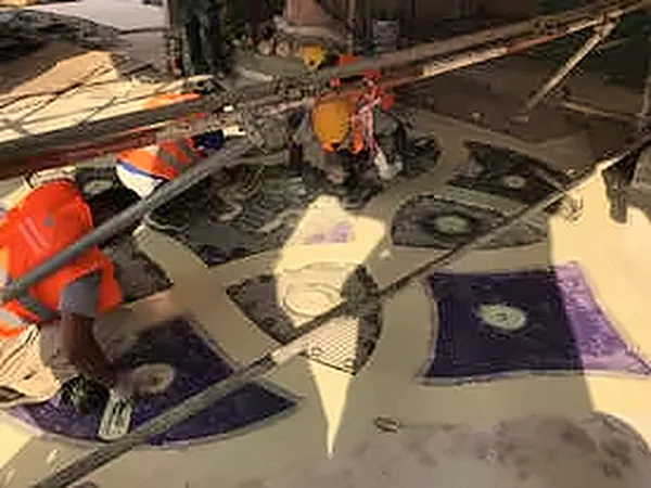 Workers laying a coloured floor medallion