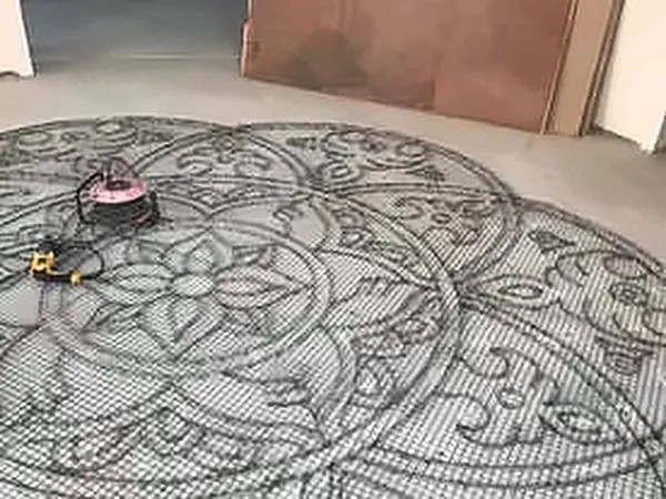 Ornate floral floor pattern taking shape on a screed floor