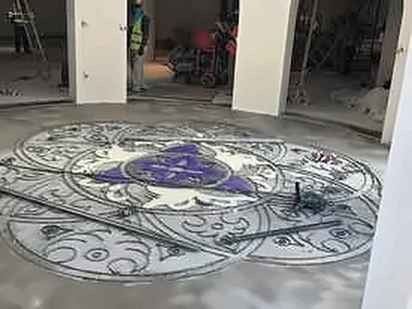 Floor medallion with purple inlay in an unfinished hall