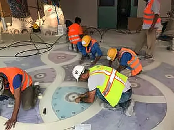 Team installing a decorative floor medallion
