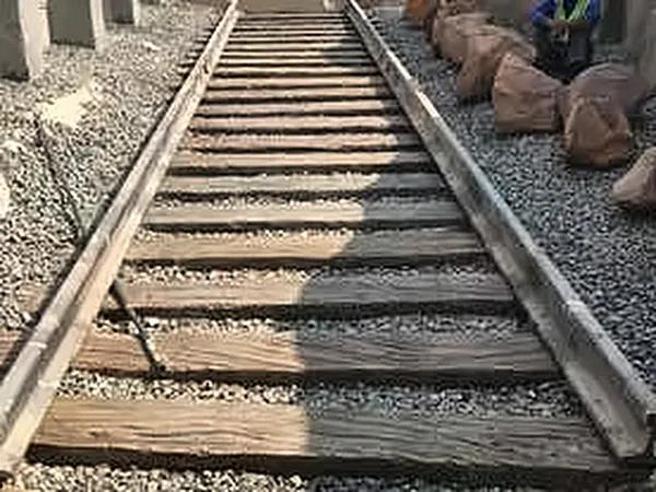 Railway track bed with ballast and timber sleepers