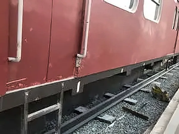 Weathered red railway carriage on the track