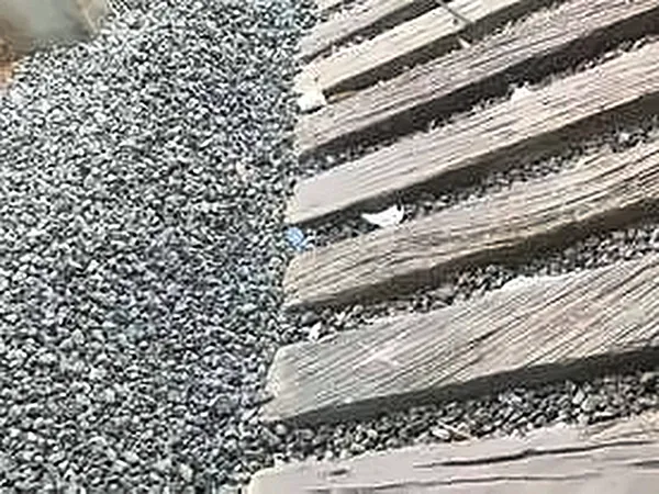 Close-up of timber planks beside gravel