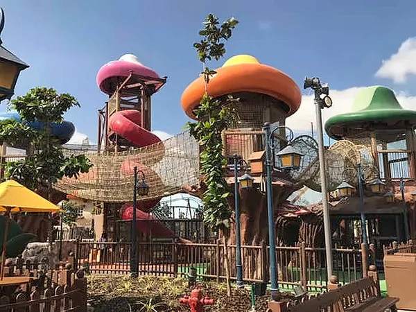 Colourful mushroom-roof play towers with rope bridges