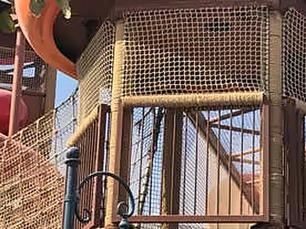 Rope netting and timber structure of a themed play tower