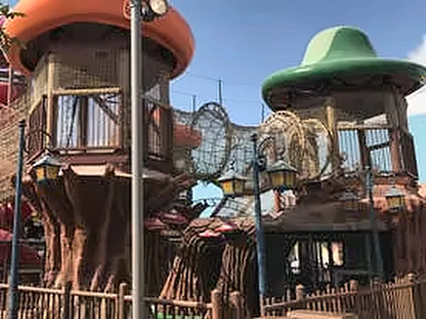 Themed play towers with green and orange mushroom roofs
