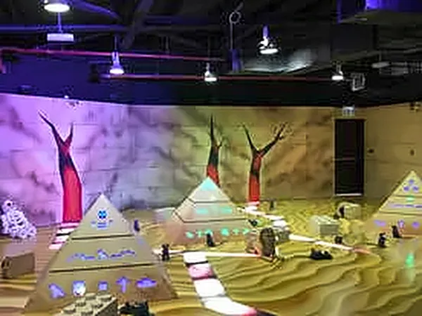 Pyramid models in front of a painted desert backdrop