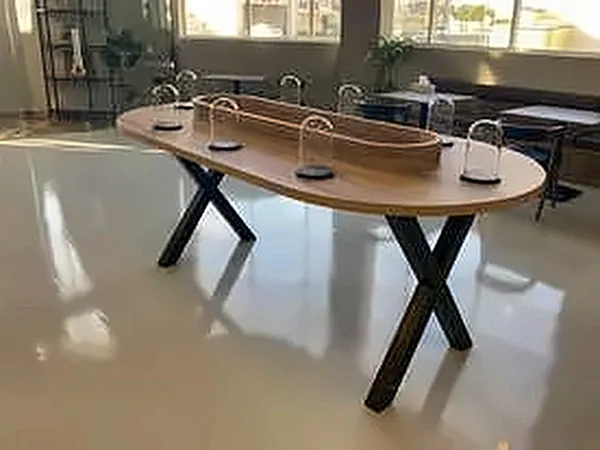 Oval timber table on black steel legs