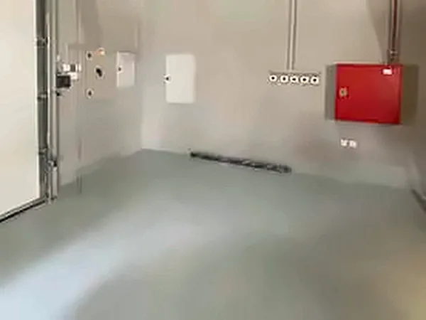 Wall-mounted red electrical panel in a finished room