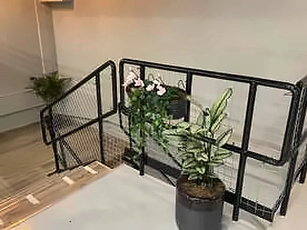 Black steel balustrade with a planter at a stairwell