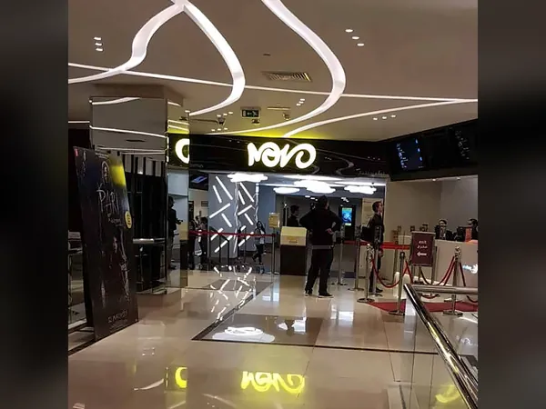 Novo Cinema lobby with sweeping ceiling light lines and illuminated signage